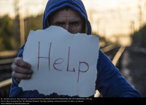 Boy holding help sign
