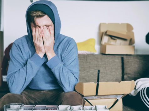 Student stressed, holding face