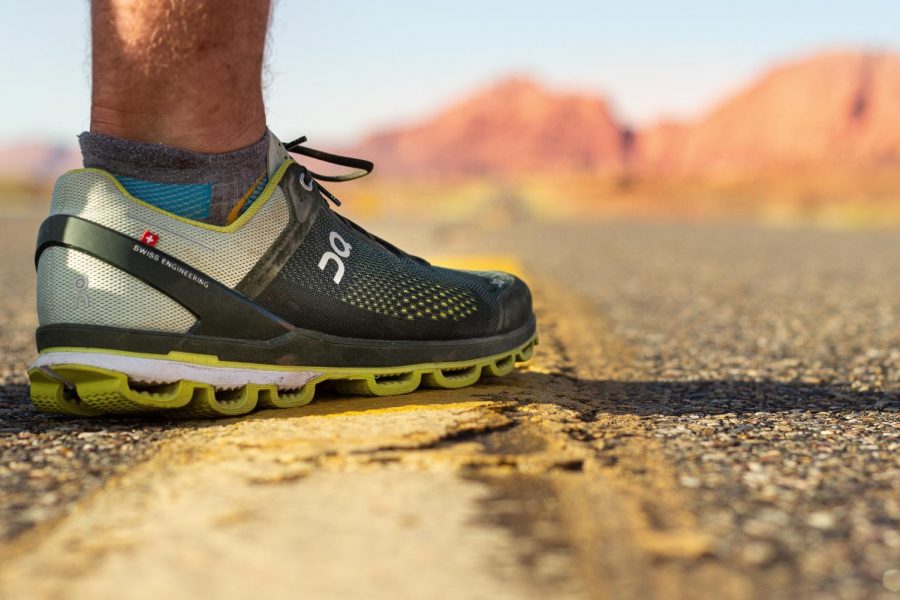 Runners foot, shoe on desert highway