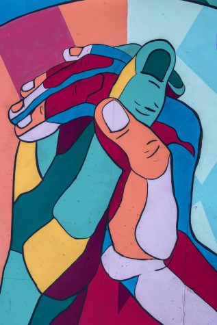 Painting of multi-colored hands glasping