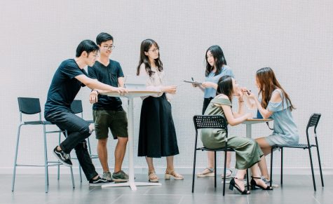 Group of six students around desks