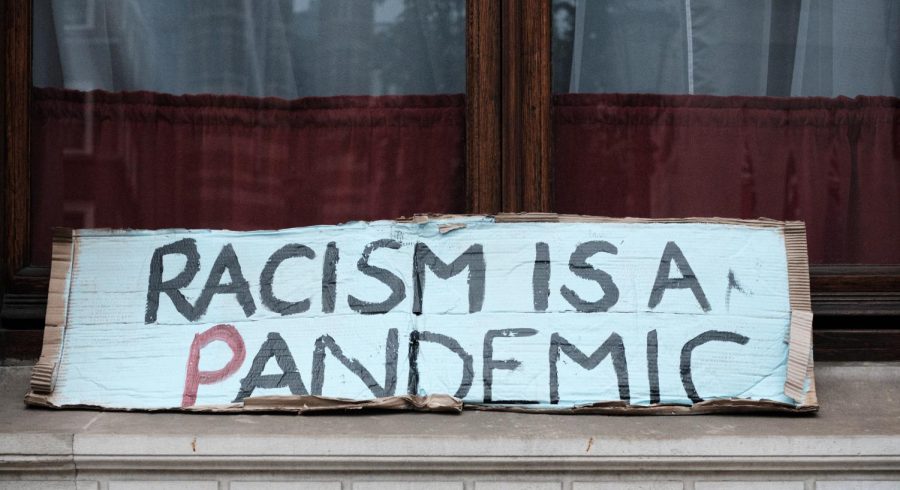 Racism is a pandemic, sign