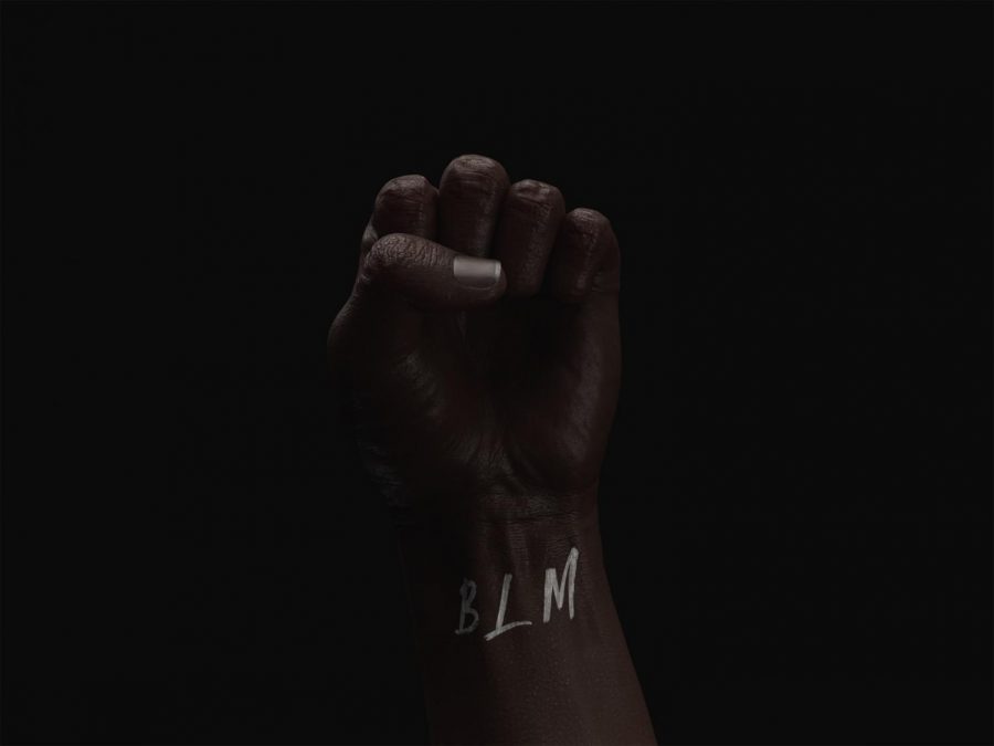 Black fist with BLM in white ink