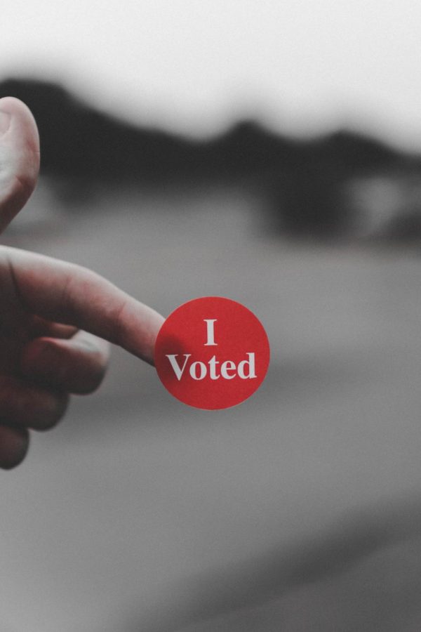 Finger holding I voted sticker
