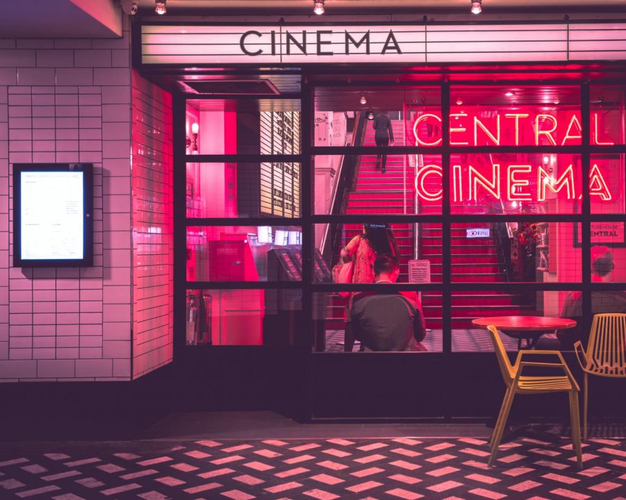 Red lit front of movie theateer
