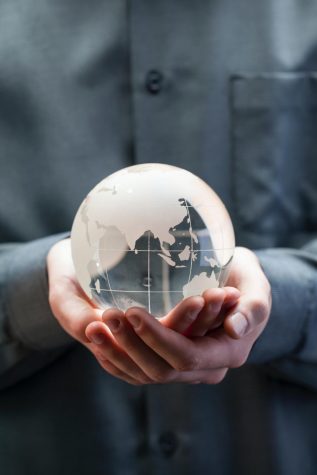 Hands holding glass globe