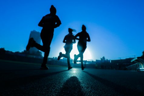 Silhouette of three runnerss
