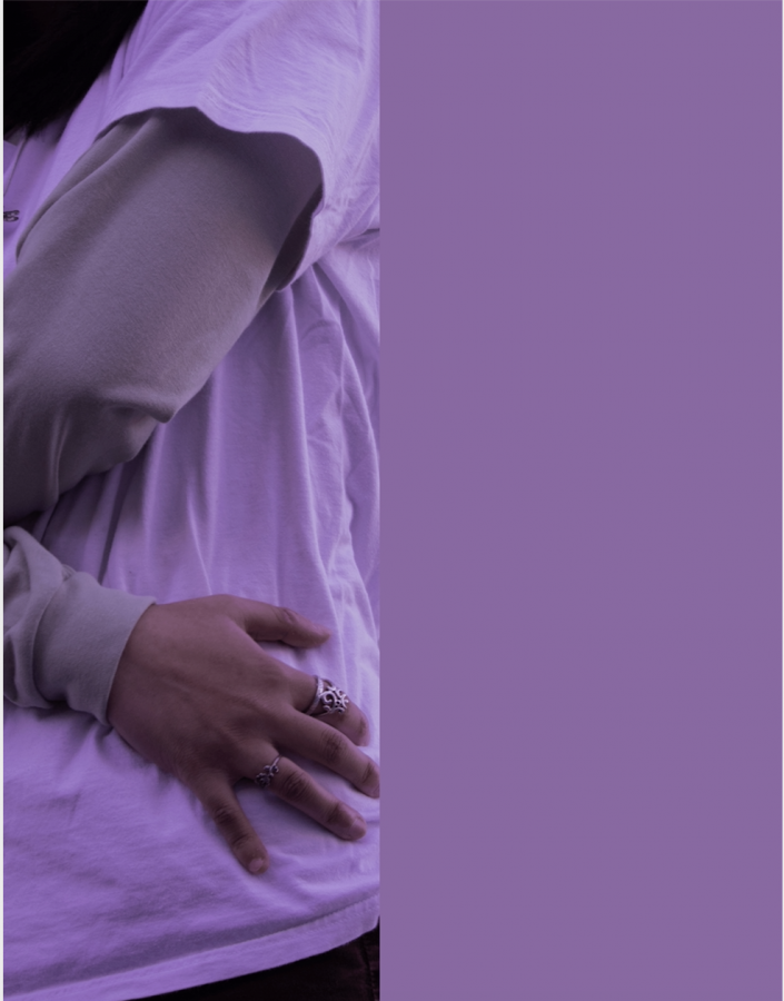 Partial body photo of student grabbing stomach, purple tilt