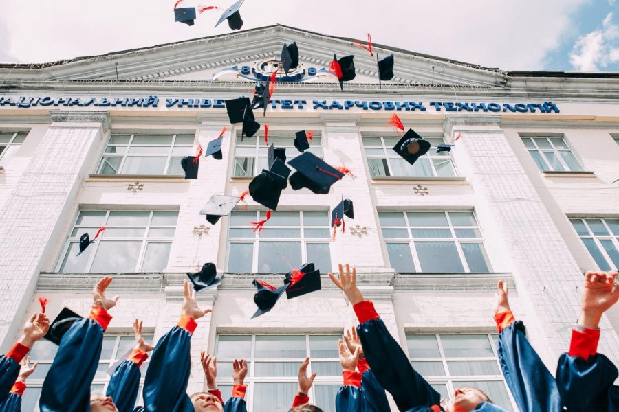 Graduates+tossing+caps+in+air