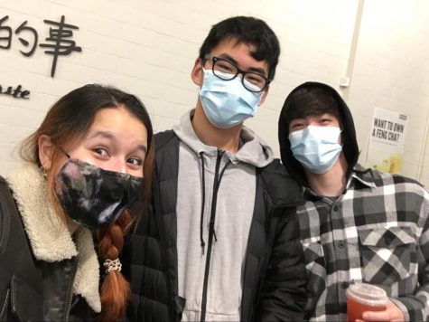 Three masked students at club meeting