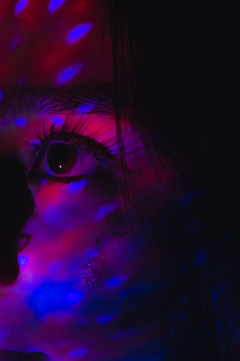 Girl close up in multi colored lights