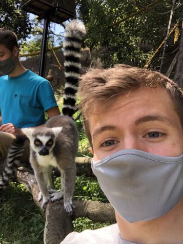 Miramonte High senior Thomas Edwardson poses alongside friendly animal while volunteering at The Oakland Zoo.