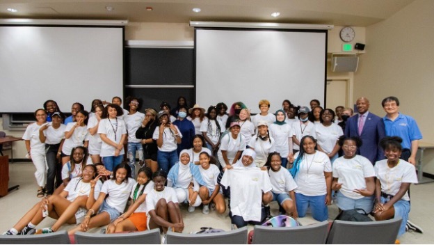 Some of the girls in the inaugural Ujima GIRL (Girls in Robotics Leadership) Project gather for a group photo with project officials in 2022. Photo courtesty of UC Davis Center for Integrated Computing and STEM Education
