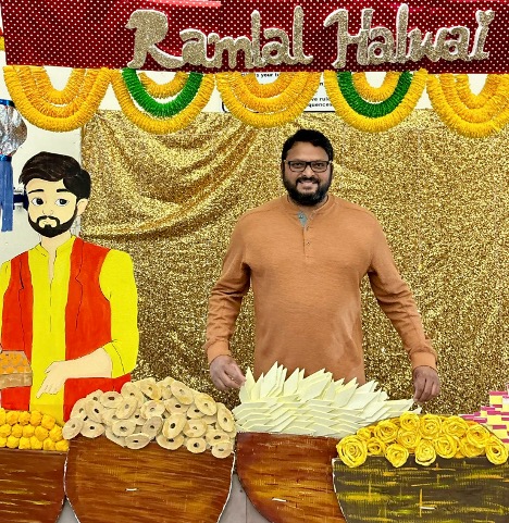 Festival-goer Vinoy Mereddy has fun at a photo prop of a fictional Indian sweet shop during the Brentwood Diwali celebration at Heritage High School. Photo courtesy of Vinoy Mereddy.