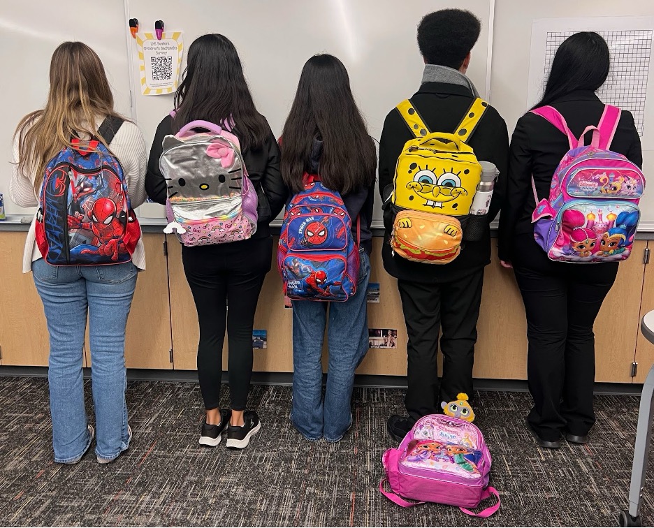 Liberty High School 12th graders model their flash from the past backpacks. 