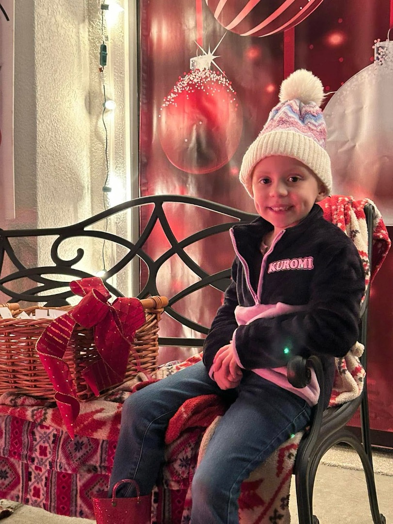 Bella Alaniz, 6, pulls names during a raffle drawing at The Hallmark House in December. Bella and her family were recipients of the 2024 Tunnels of Joy fundraiser. Photo credit: Facebook