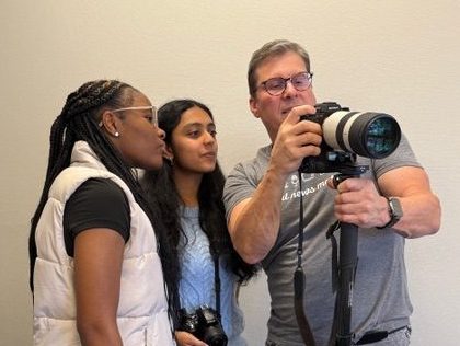 Contra Costa Youth Journalism reporters Nakalya Conner, left, of Pittsburg High School, and Ishita Khanna of Heritage High School, receive photojournalism training from Ray Saint German, a CCYJ mentor and Bay City News photo editor.