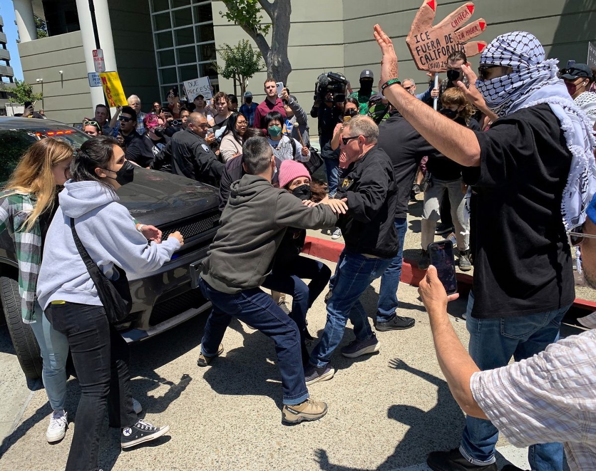 Federal agents remove a protester from in front of a vehicle containing local immigrants who had attended immigration hearings at the Concord Immigration Court on June 10, 2025. (Photo Credit: Tony Hicks/Bay City News)

