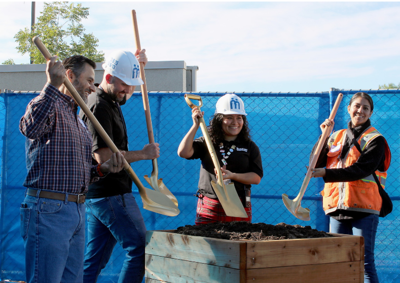 Participants at the Monument Crisis Center groundbreaking raise gold shovels to ceremonially dig into dirt representing planned construction of a new addition to the center’s food pantry in Concord on Oct. 9, 2025.

