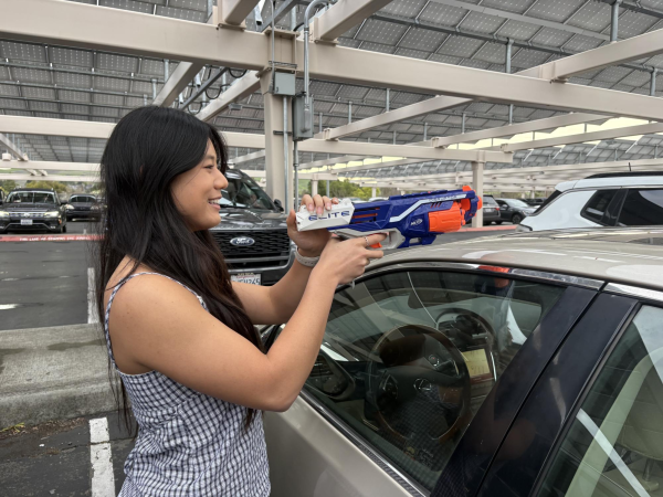 California High School 12th grader Elise Lee practices aiming her Nerf toy gun at unsuspecting targets in the California High School parking lot in San Ramon. Photo by Lauren Aparicio 