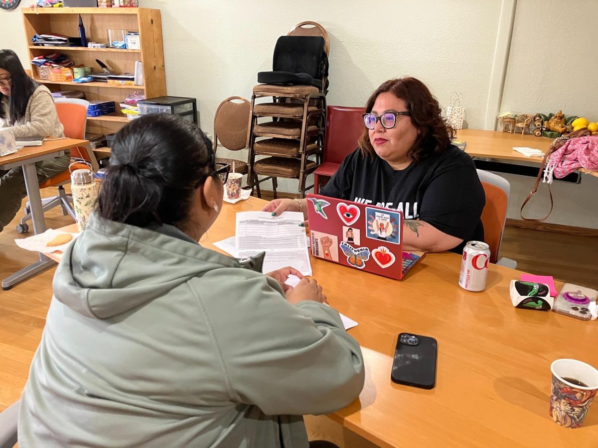 Veronica B. Granillo, a staff attorney at East Bay Covenant Sanctuary, consults with a colleague. (Photo courtesy of the East Bay Covenant Sanctuary) 

