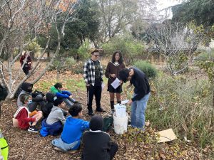 High school students teach elementary school kids about planting native plants in a garden as part of a Growing Together greening program. (Photo courtesy of Growing Together)
